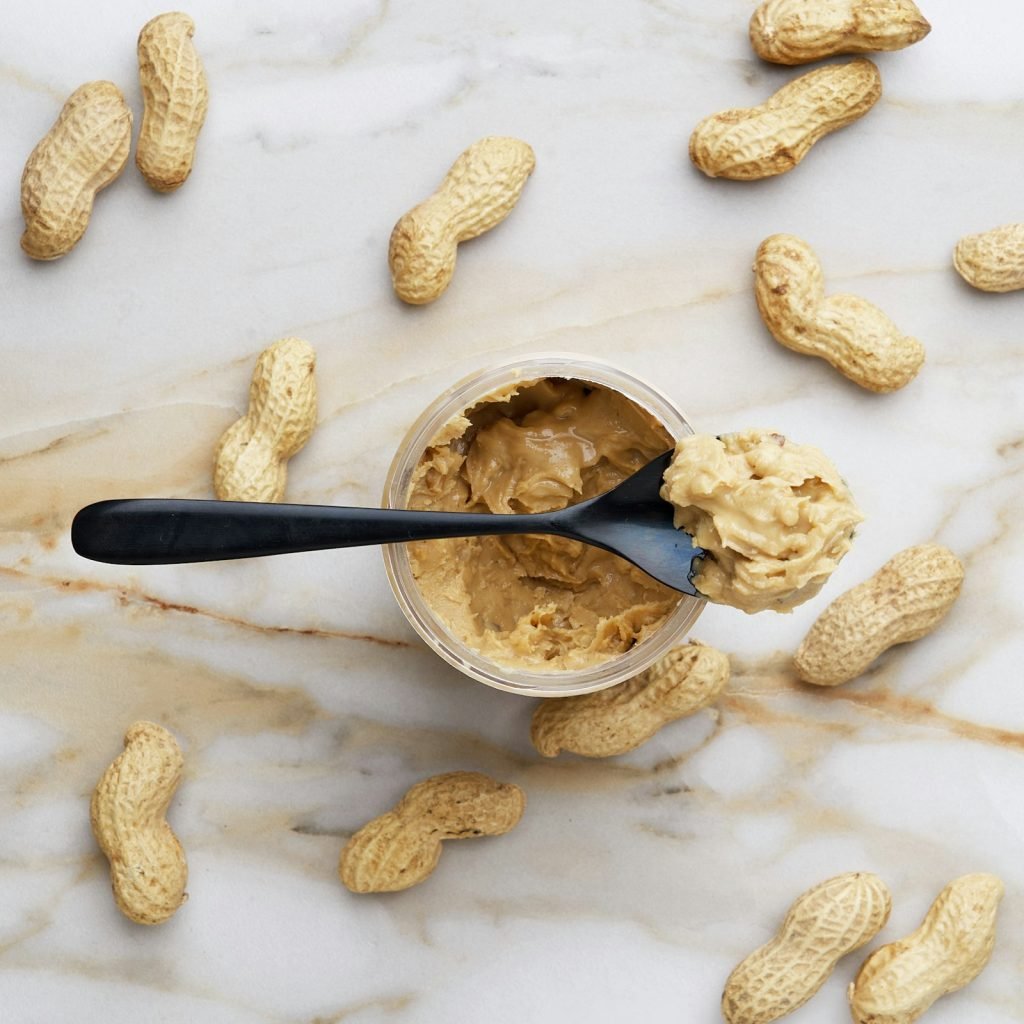 A jar of peanut butter with a spoon