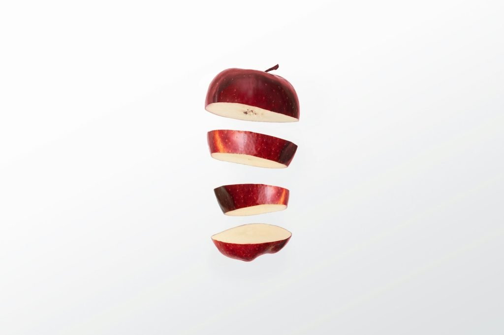 A red apple sliced into pieces