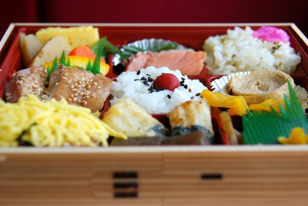 A wooden box filled with different types of food